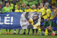 Brazil's players shows a banner in support of Brazilian soccer legend Pele at the end of the World Cup round of 16 soccer match between Brazil and South Korea, at the Stadium 974 in Doha, Qatar, Monday, Dec. 5, 2022. (AP Photo/Andre Penner)