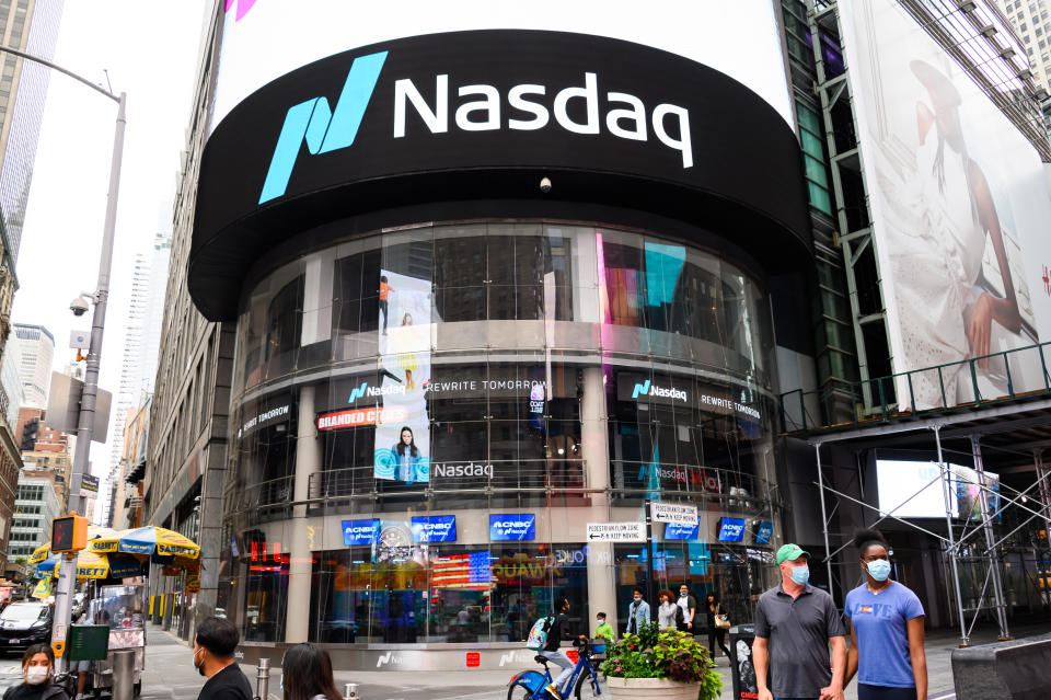 NEW YORK, NEW YORK - AUGUST 16: People wear protective face masks outside Nasdaq in Times Square as the city continues Phase 4 of re-opening following restrictions imposed to slow the spread of coronavirus on August 16, 2020 in New York City. The fourth phase allows outdoor arts and entertainment, sporting events without fans and media production. (Photo by Noam Galai/Getty Images)