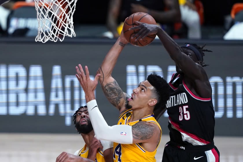 Portland Trail Blazers forward Wenyen Gabriel, right, blocks a shot by Lakers guard Danny Green.