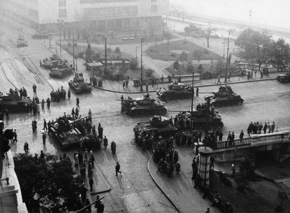 FILE - Dozens of tanks guard the intersection that leads on to the Danube Bridge during the Hungarian Insurrection on Nov. 2, 1956 in Budapest. The Immigration and Nationality Act of 1952 lets the president grant entry for humanitarian reasons and matters of public interest. Previous administrations have admitted large numbers of Hungarians, Vietnamese and Cubans. (AP Photo, File)