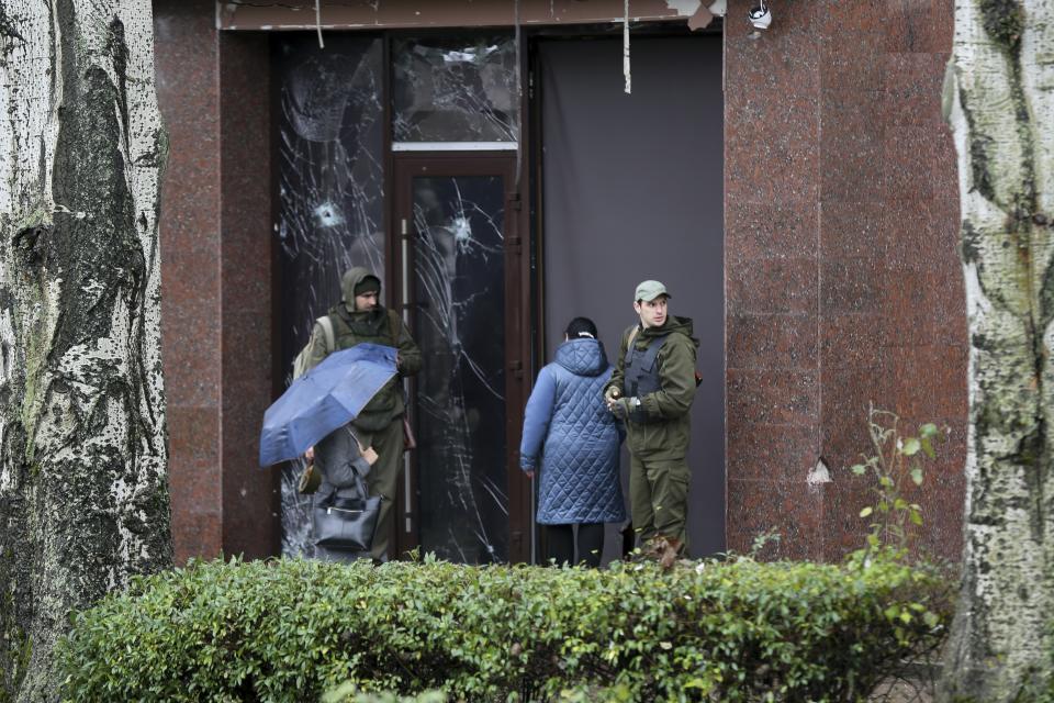 Servicemen guard the entrance of a government building in Donetsk, the capital of Donetsk People's Republic, eastern Ukraine, Thursday, Oct. 20, 2022. Russian President Vladimir Putin made on Wednesday a declaration of martial law in the four illegally annexed regions. (AP Photo)