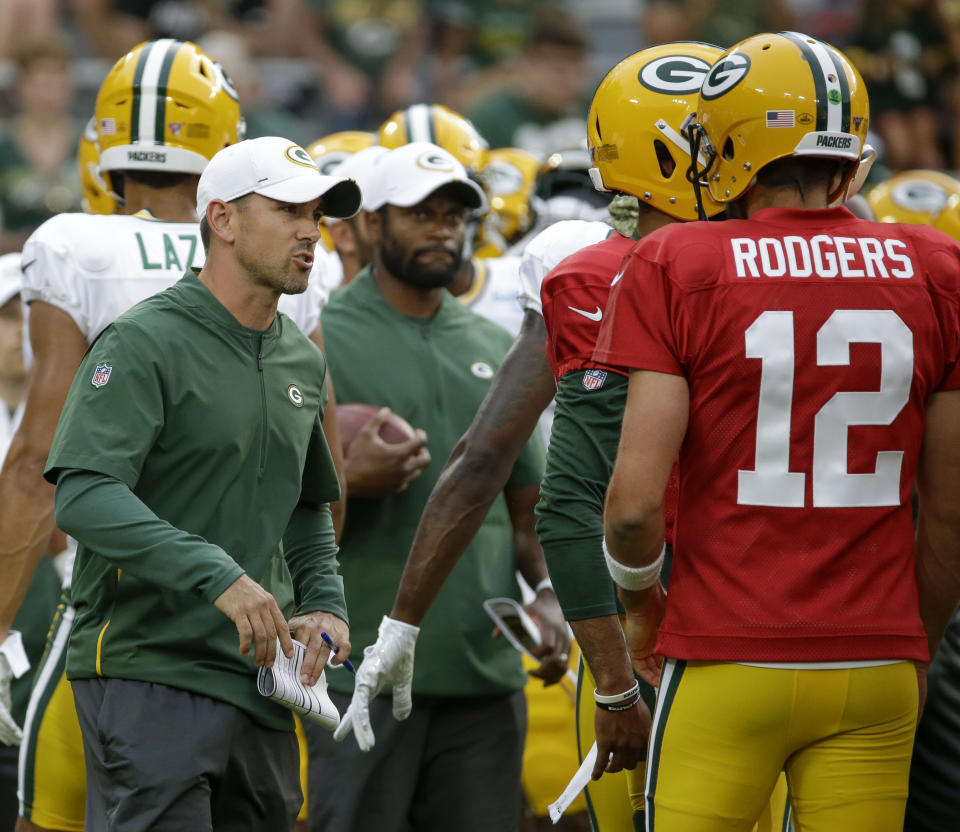 Green Bay Packers coach Matt LaFleur, left, talks with quarterback Aaron Rodgers during the NFL football team's Family Night practice Friday Aug 2, 2019, in Green Bay, Wis. (AP Photo/Mike Roemer)