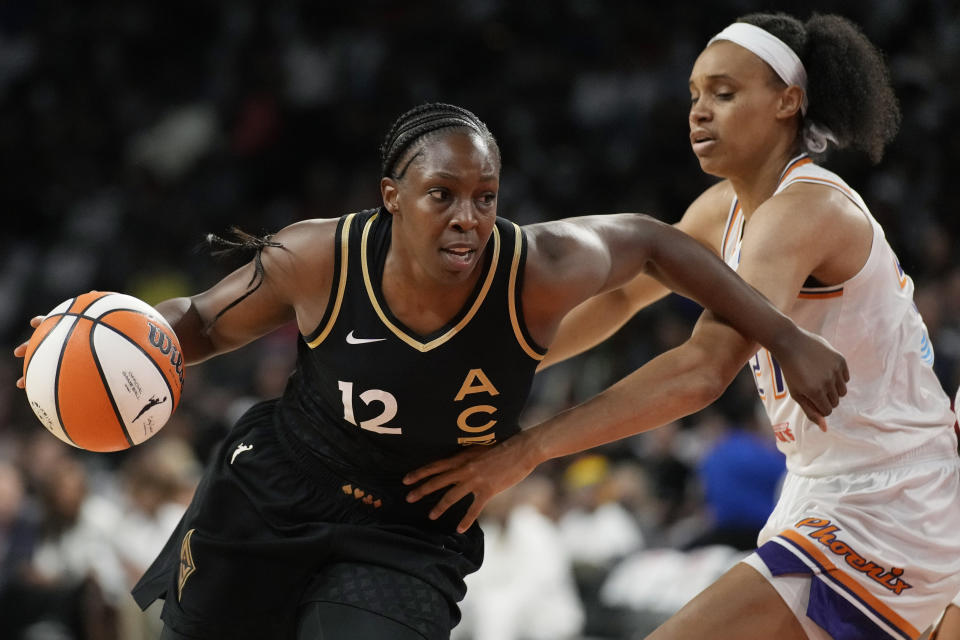 Las Vegas Aces guard Chelsea Gray drives around Phoenix Mercury forward Brianna Turner during the first half in Game 1 of a WNBA first-round playoff series on Aug. 17, 2022, in Las Vegas. (AP Photo/John Locher)