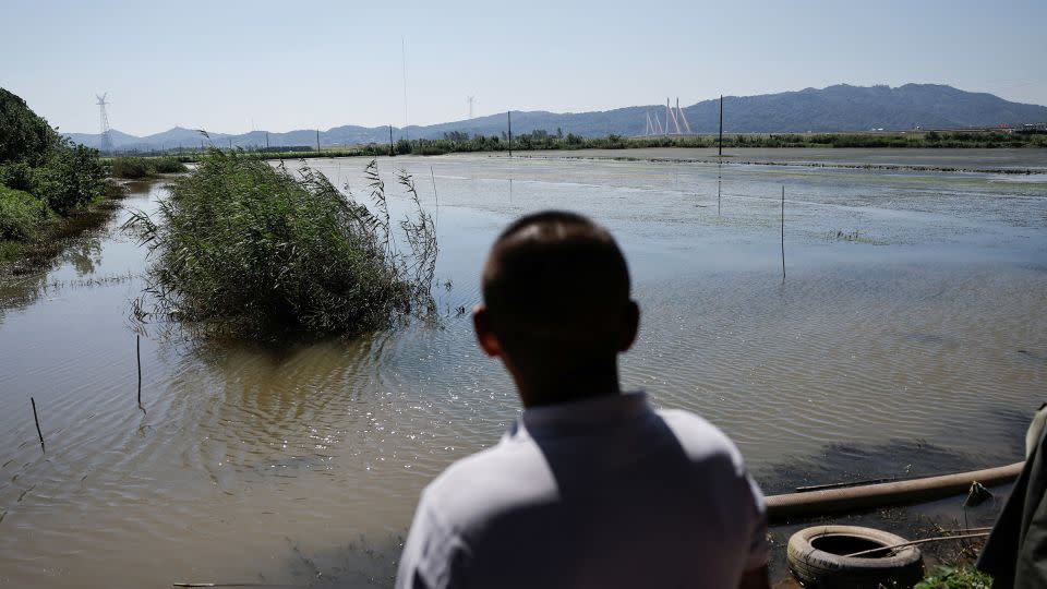 Un agricultor de la provincia de Jiangxi observa sus tierras inundadas el 5 de julio, tras días de fuertes lluvias. - Tingshu Wang/Reuters