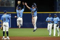 Tampa Bay Rays shortstop Wander Franco (5) and center fielder Brett Phillips celebrate with teammates after defeating the Boston Red Sox during a baseball game Wednesday, June 23, 2021, in St. Petersburg, Fla. (AP Photo/Chris O'Meara)