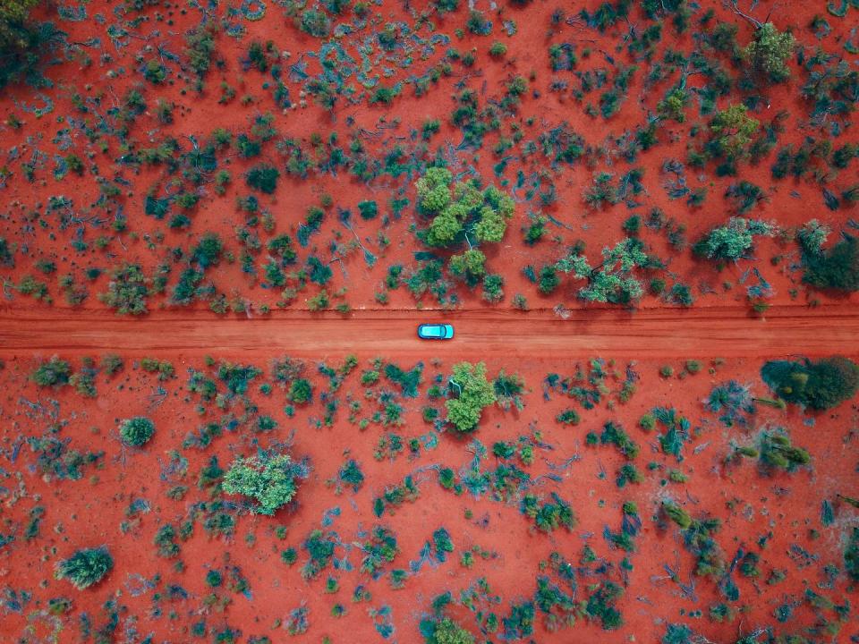 <p>A car drives across the "red centre" of the outback.</p>