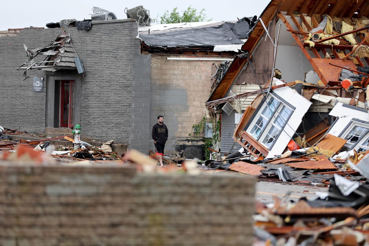 A man looks at tornado damage in Sulphur, Okla., Sunday, April 28, 2024, after severe storms hit the area the night before.