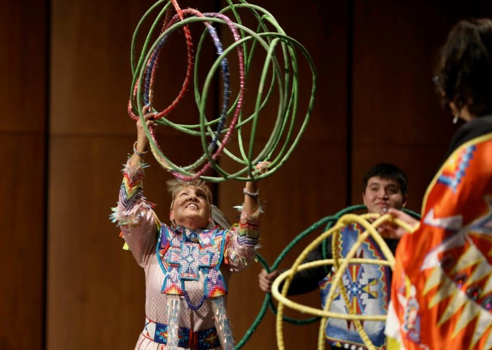 With help from her family, Jackie Bird presents a hoop dance to attendees at the Johnson Fine Arts Center at Northern Thursday evening. The dance is an expression of healing and the circle of life. She uses 38 hoops to tell the story of creation. This evening's presentation was the final event celebrating Native American Heritage Month and was jointly sponsored by Northern, Presentation College and Central High School's Native American Student Association.