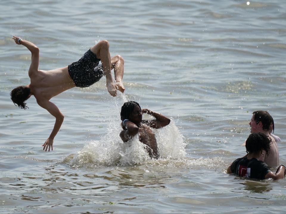 Teenagers playing in the sea at Southend-on-Sea (PA)