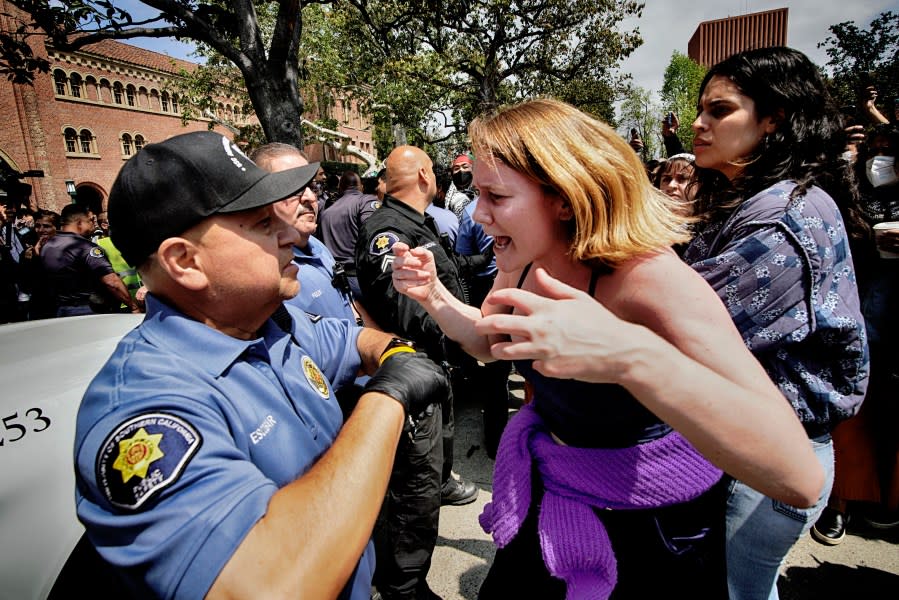 A University of Southern California protester, right, confronts a University Public Safety officer at the campus’ Alumni Park during a pro-Palestinian occupation on Wednesday, April 24, 2024, in Los Angeles. (AP Photo/Richard Vogel)