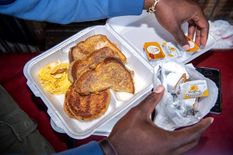 A foam container holds Lionel Boyce's takeout order of French toast and salmon croquettes