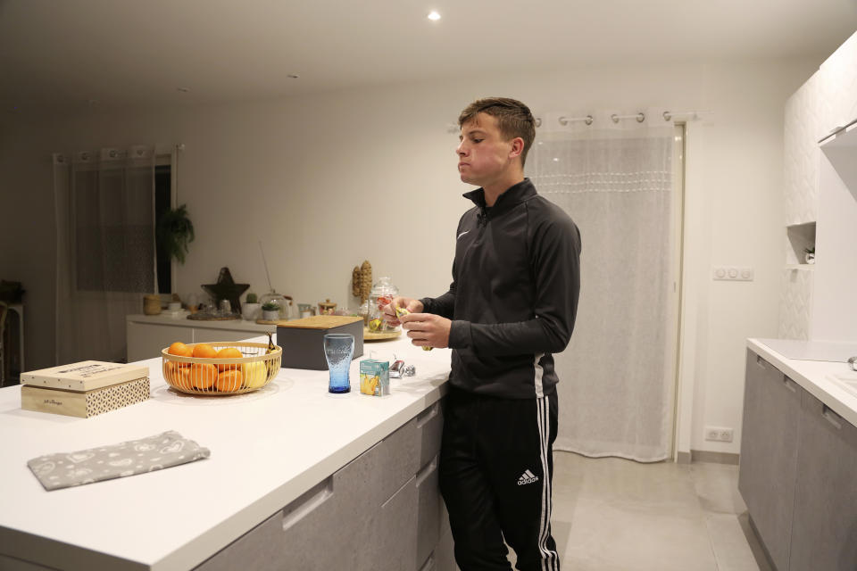 Evan Cesa, 18, eats his breakfast at his home near Nice, southern France, Monday, Feb. 8, 2021, with little appetite because he has lost his sense of smell and taste since he contracted COVID-19 in September 2020. A year into the coronavirus pandemic, doctors are striving to better understand and treat patients who lose their sense of smell. (AP Photo/John Leicester)