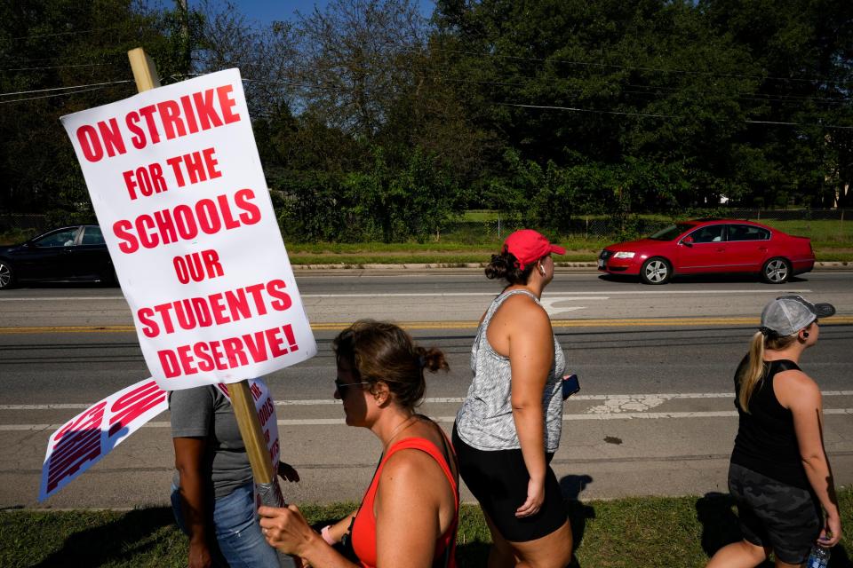 Rebecca Chenault, left, walks the picket line at the Columbus Spanish Immersion School as the Columbus Education Association strike continued for a third day Wednesday, which was also the first day of classes.