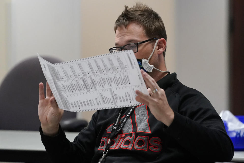 An election worker checks ballots in the elections management center at Salt Lake County Government Center Tuesday, Nov. 3, 2020, in Salt Lake City. . (AP Photo/Rick Bowmer)