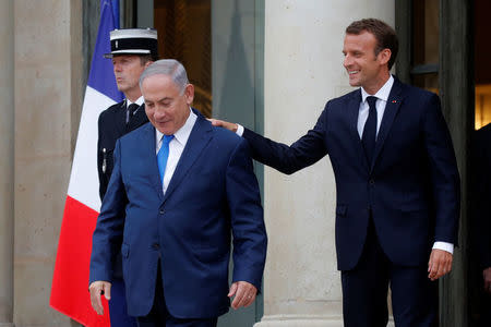 French President Emmanuel Macron escorts Israeli Prime Minister Benjamin Netanyahu as he leaves the Elysee Palace in Paris, France, June 5, 2018. REUTERS/Philippe Wojazer