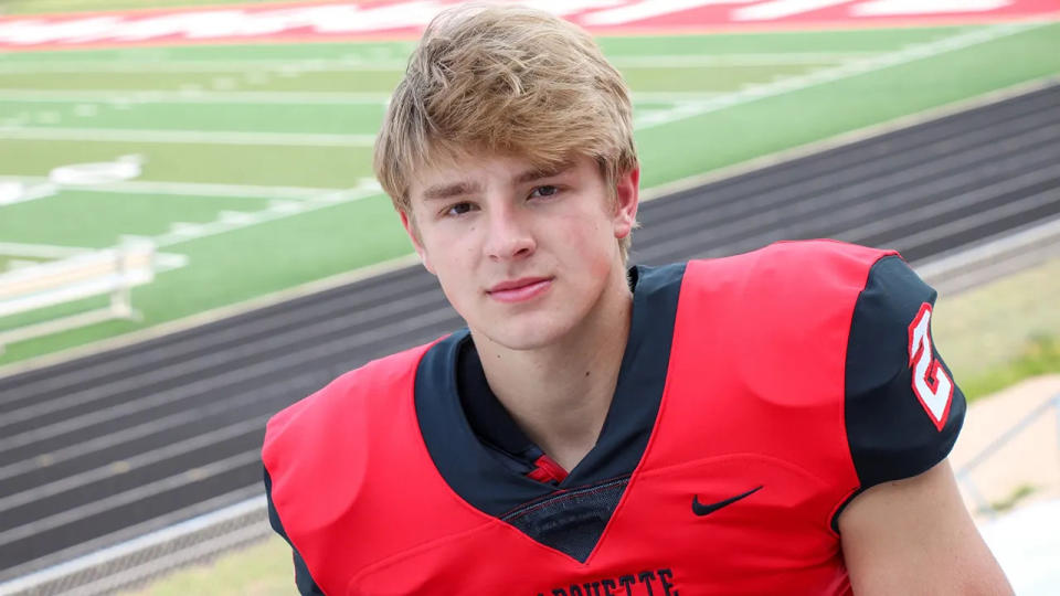 Jordan DeMay wears a football jersey