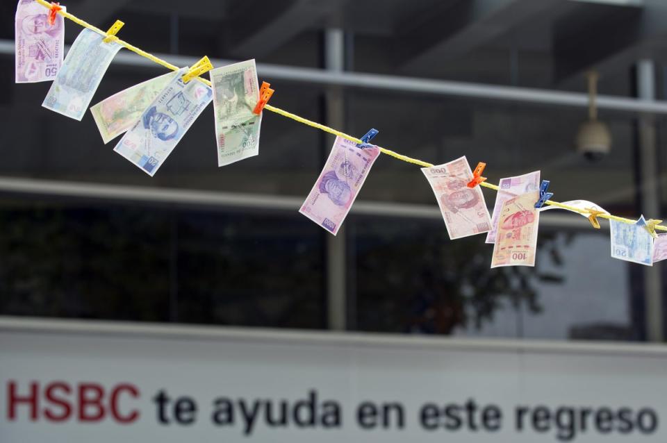 Fake notes were put in the sun ‘to dry’ during a protest in front of a HSBC branch building in Mexico City (AFP/Getty)