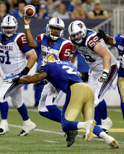 CFL Football - Winnipeg Blue Bombers v Montreal Alouettes - Winnipeg, Manitoba , Canada - 24/6/16. Alouettes&#39; Kevin Glenn (L) passes while being tackled by   Blue Bombers&#39; Khalil Bass.   REUTERS/Lyle Stafford