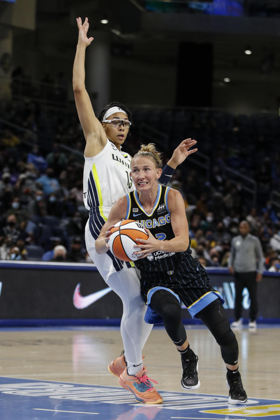 Chicago Sky guard Courtney Vandersloot (22) drives to the basket past Dallas Wings guard Allisha Gray (15) during the first half in the first round of the WNBA basketball playoffs, Thursday, Sept. 23, 2021, in Chicago. (AP Photo/Kamil Krzaczynski)