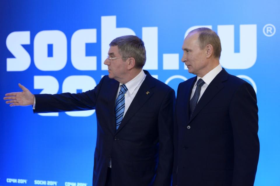 Russian President Vladimir Putin, right, greets International Olympic Committee President Thomas Bach at an event welcoming IOC members ahead of the upcoming 2014 Winter Olympics at the Rus Hotel, in Sochi, Russia, Tuesday, Feb. 4, 2014. (AP Photo/RIA-Novosti, Alexei Nikolsky, Presidential Press Service)