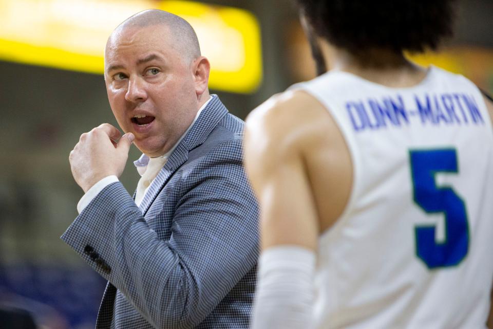 Florida Gulf Coast head coach Michael Fly talks with guard Tavian Dunn-Martin (5) during a timeout March 16 in Fort Myers, Fla.