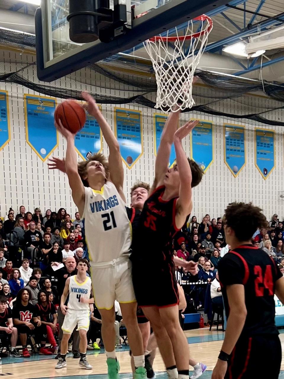River Valley's Ayden Kenney shoots a layup against the defense of Marion Harding's Boston Pearson during a boys basketball game Friday night at RV.