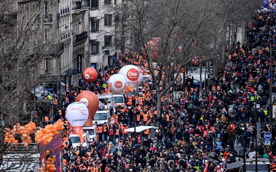 People take part in a demonstration in Paris over Emmanuel Macron's proposed pensions overhaul - ALAIN JOCARD/AFP via Getty Images