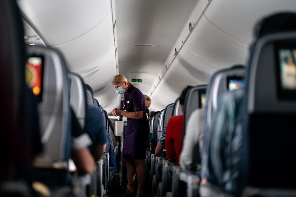 ARLINGTON, VA - MAY 21: Flight attendants hand out refreshments to a packed Delta Airlines flight traveling from Ronald Regan National Airport to MinneapolisSaint Paul International Airport on Friday, May 21, 2021. (Kent Nishimura / Los Angeles Times via Getty Images)