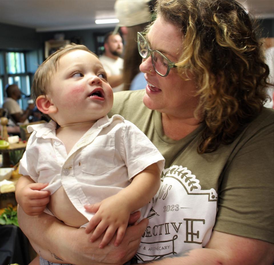 NIchole Reno-Meiron at her barbershop's soft opening with grandson Atlas. Five generations of her family were present.