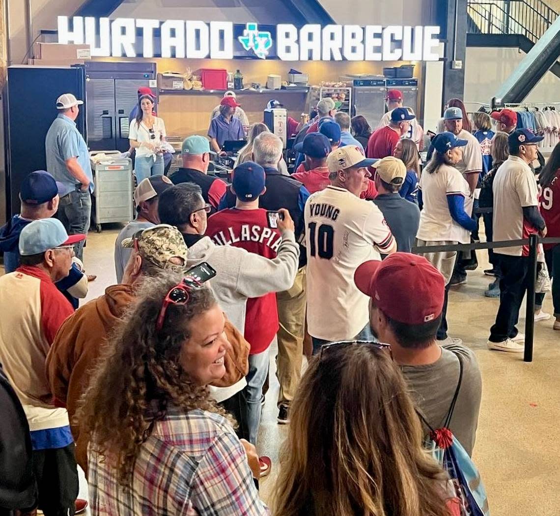 A typical line at opening time for Hurtado Barbecue’s stand near center field at Globe Life Stadium.
