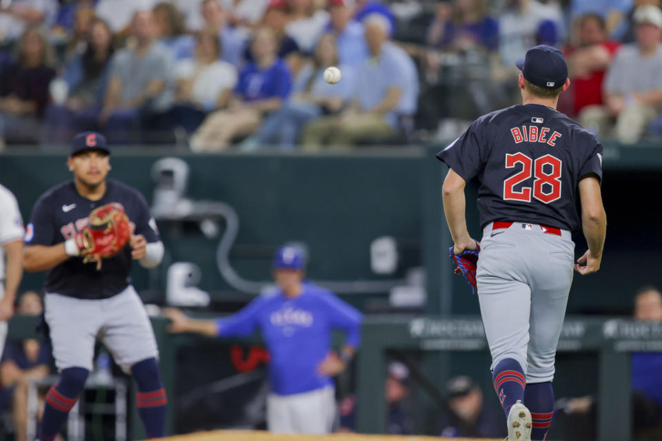 Cleveland Guardians starting pitcher Tanner Bibee (28) fields a ground ball and throws out Texas Rangers’ <a class="link " href="https://sports.yahoo.com/mlb/players/11662/" data-i13n="sec:content-canvas;subsec:anchor_text;elm:context_link" data-ylk="slk:Jonah Heim;sec:content-canvas;subsec:anchor_text;elm:context_link;itc:0">Jonah Heim</a> at first base during the fifth inning of a baseball game Monday, May 13, 2024, in Arlington, Texas. (AP Photo/Gareth Patterson)