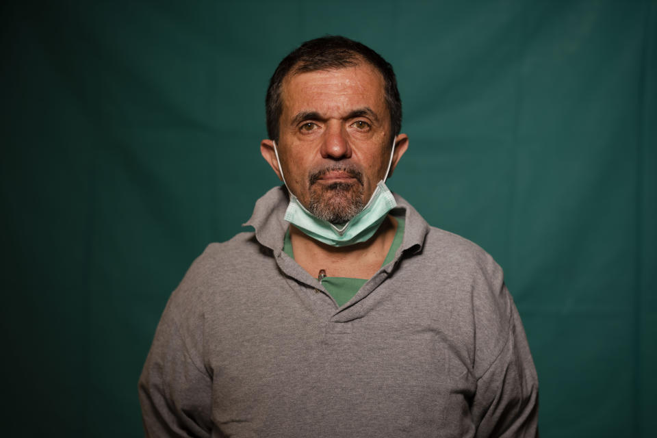 Doctor Sebastiano Petracca, 48, head physician of the ICU at the Rome's COVID 3 Spoke Casalpalocco Clinic poses for a portrait, Friday, March 27, 2020, during a break in his daily shift. Their eyes are tired. Their cheekbones are rubbed raw from protective masks. They don't smile. The intensive care doctors and nurses on the front lines of the coronavirus pandemic in Italy are often almost unrecognizable behind their masks, scrubs, gloves and hairnets their only barrier to contagion. (AP Photo/Domenico Stinellis