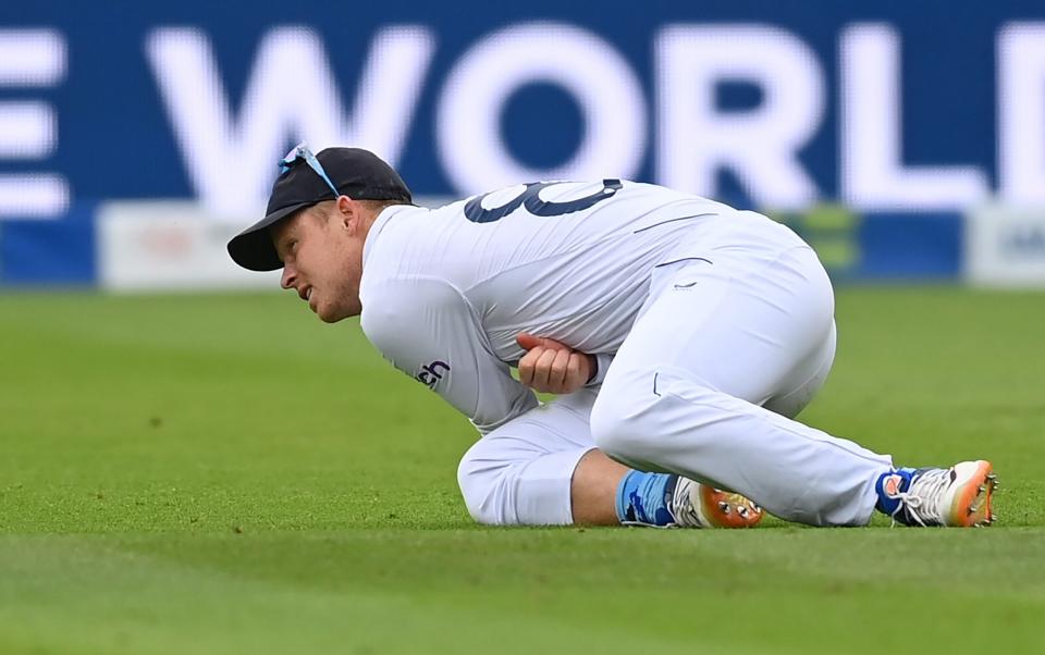 Ollie Pope of England goes down with an injury after landing on his dislocated shoulder again