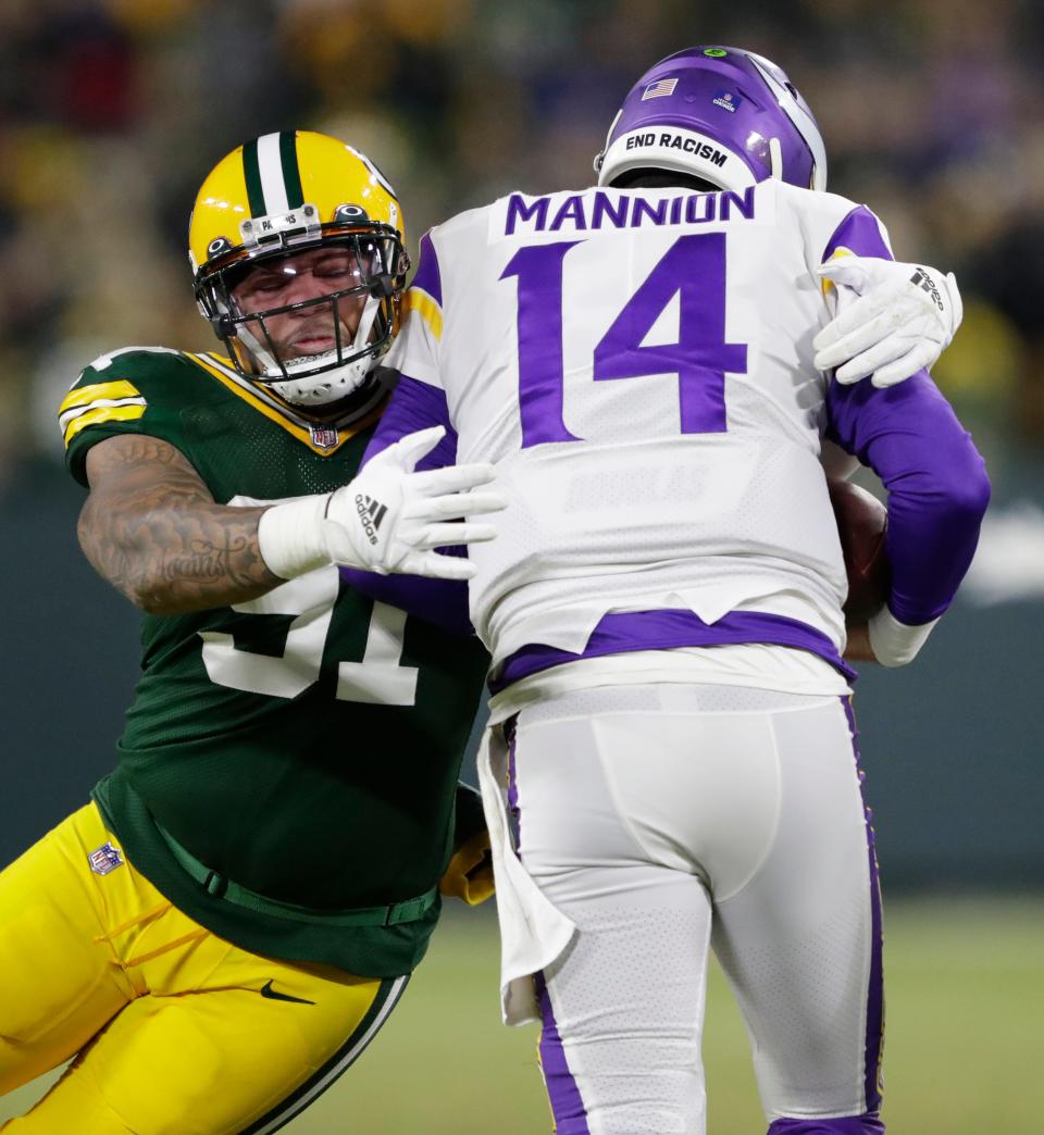 Green Bay Packers outside linebacker Preston Smith sacks Minnesota Vikings quarterback Sean Mannion in the second quarter on Jan. 2, 2022, at Lambeau Field in Green Bay.