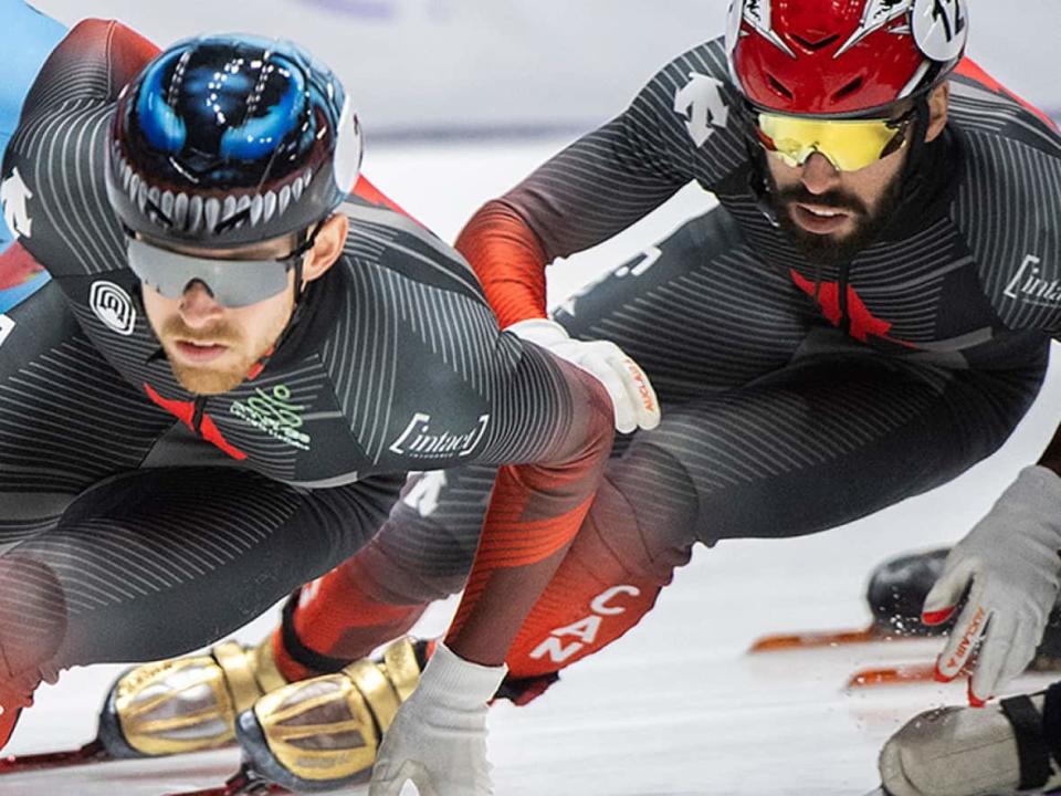 Steven Dubois of Terrebonne, Que., right, held off South Korea's Hong Kyung Hwan in a photo finish, placing second in the men's 1,500-metre A final on Saturday at a World Cup short track event in Montreal. (Graham Hughes/Canadian Press - image credit)