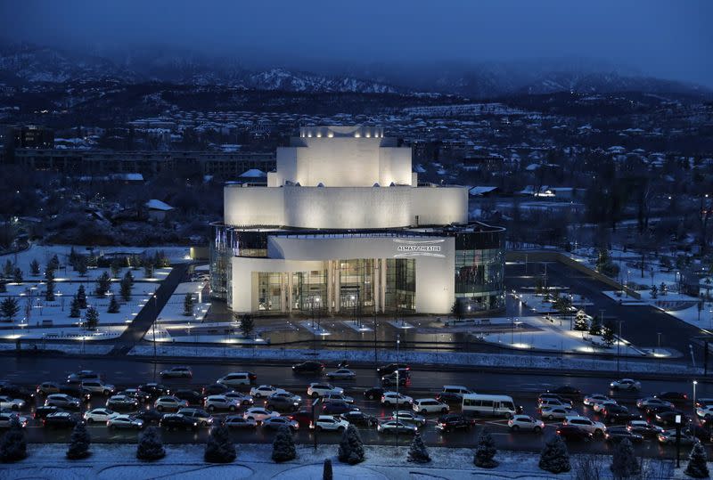 Cars drive past the Almaty theatre building in Almaty
