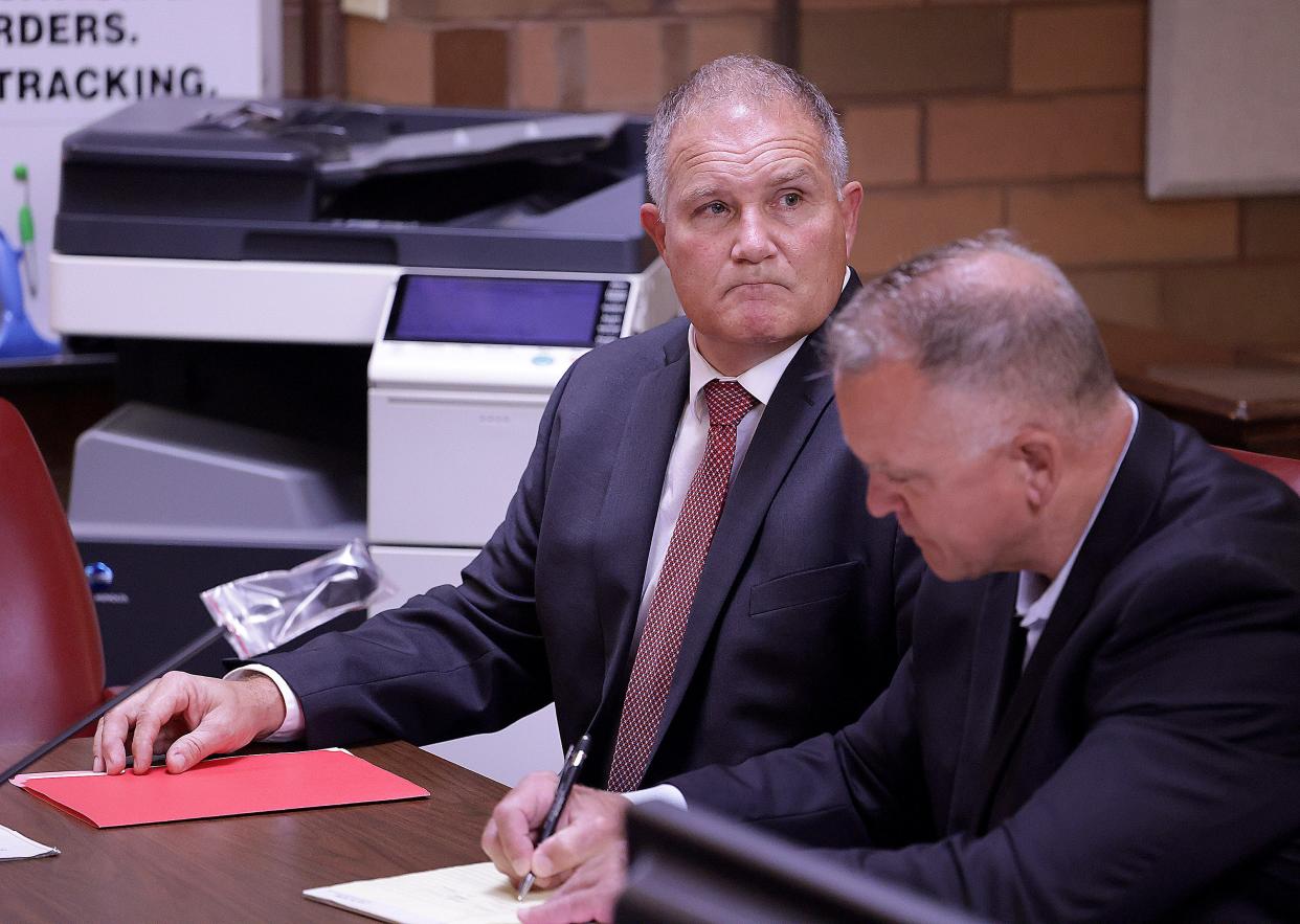 Canton Local school board member Scott Hamilton, left was conivcated of a theft charge in June for stealing pine shavings from Tractor Supply Co. To his right is his attorney Daniel Funk. Hamilton is facing a new theft charge accusing him of stealing yard signs demanding his resignation from the school board.