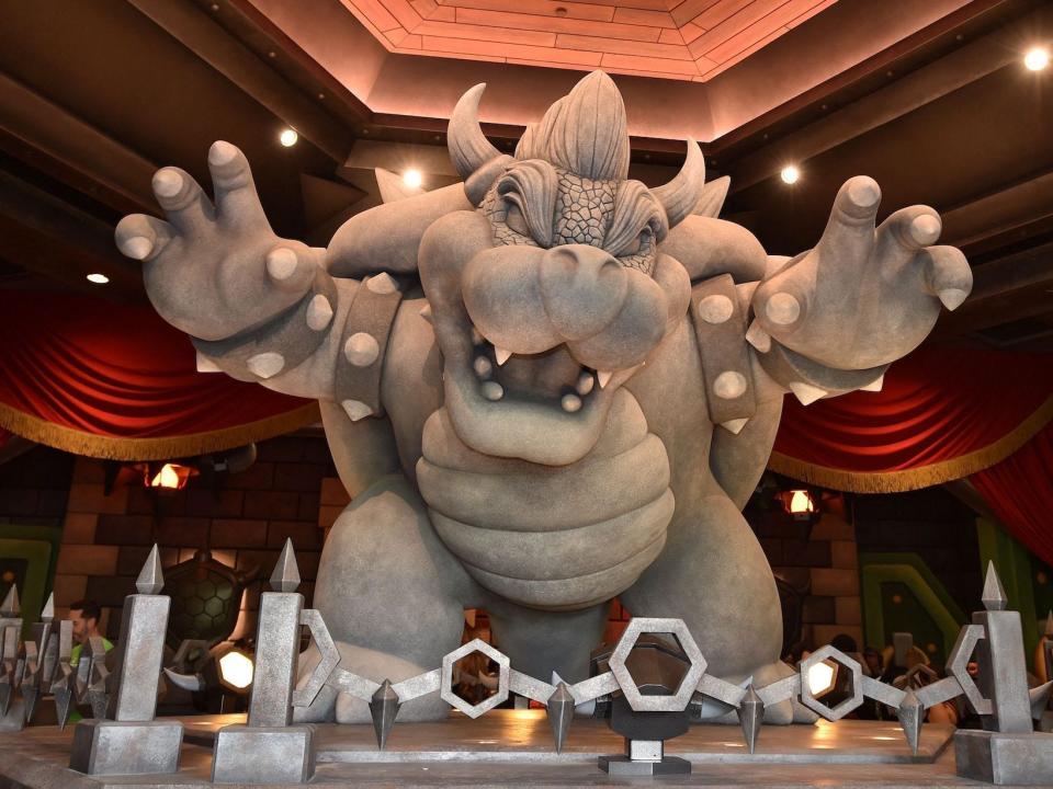 A statue of Bowser is seen at the entrance of the Mario Kart Bowser's Challenge ride during a preview of Super Nintendo World at Universal Studios in Los Angeles, California, on January 13, 2023.