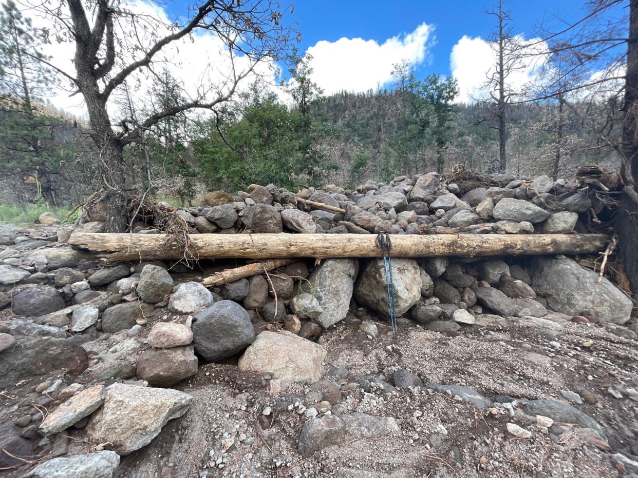 Boulders, logs and other debris sit in a a flood channel created after a 2021 storm over the Museum Fire burn scar near Flagstaff. The flow was able to move boulders approximately 1 meter in size.