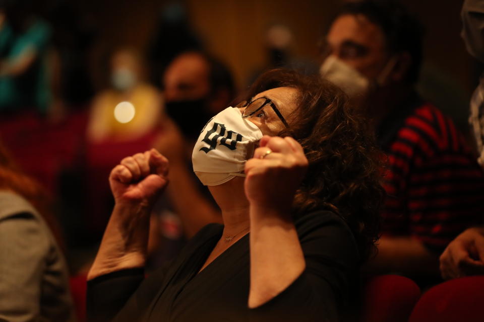 Magda Fyssa, the mother of late Greek rap singer Pavlos Fyssas, who was stabbed and killed by a supporter of the extreme right Golden Dawn party in 2013 triggering a crackdown on the party, celebrates immediately after the delivery of the verdict of a court decision in Athens, Wednesday, Oct. 7, 2020. The court ruled that the far-right Golden Dawn party was operating as a criminal organization, delivering a landmark guilty verdict in a marathon five-year trial.The court ruled seven of the party's former lawmakers, including party leader Nikos Michaloliakos, were guilty of leading a criminal organization, while the others were guilty of participating in a criminal organization. (AP Photo/Petros Giannakouris)