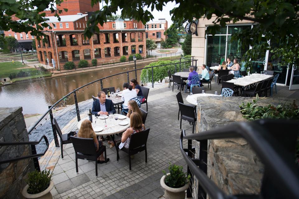 Guests enjoy dinner on the patio of The Lazy Goat in downtown Greenville on Thursday, June 8, 2017.