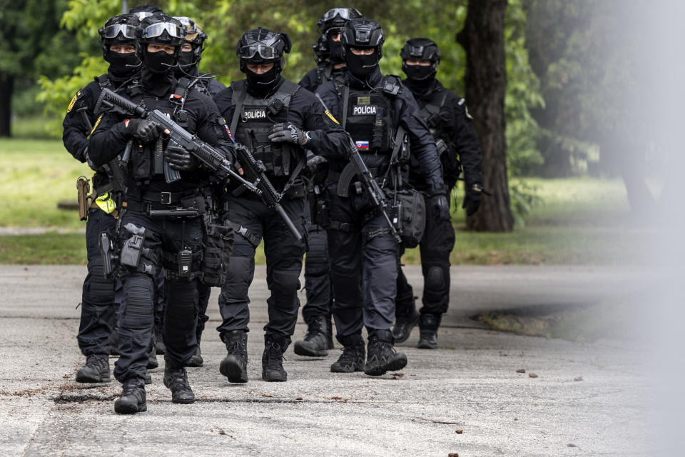 Policemen guard the area as they wait for the suspect, in shooting of Slovakia's Prime Minister Robert Fico, to be brought to court in Pezinok, Slovakia, Saturday, May 18, 2024. Officials in Slovakia say Prime Minister Robert Fico has undergone another operation two days after his assassination attempt and remains in serious condition. (AP Photo/Tomas Benedikovic)