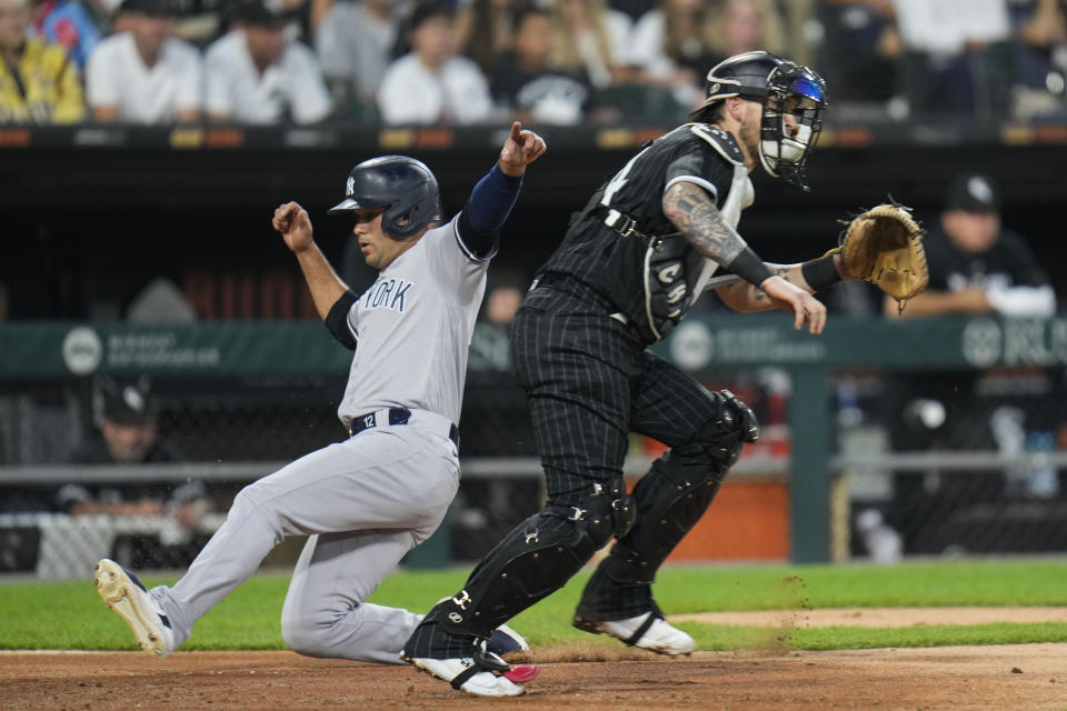 New York Yankees' Isiah Kiner-Falefa, left, slides past Chicago White Sox catcher Yasmani Grandal to score during the fourth inning of a baseball game Tuesday, Aug. 8, 2023, in Chicago. (AP Photo Erin Hooley)