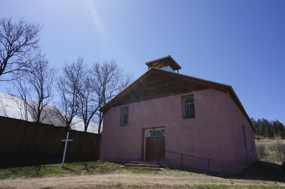 An exterior view of the San Jose Catholic church stands in the hamlet of Ledoux, New Mexico, Saturday, April 15, 2023. Hundreds of historic adobe churches like this survive in northern New Mexico, cared for by "mayordomos" even though Mass is celebrated there only a couple of times per year. (AP Photo/Giovanna Dell'Orto)