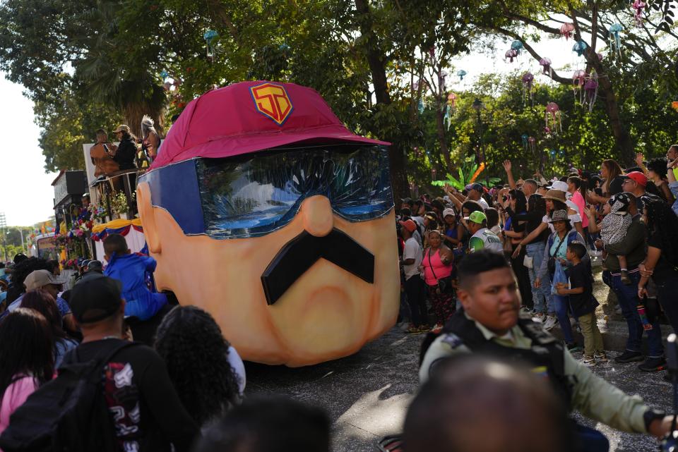 A carnival float depicting Super Mustache, or "Super Bigote" in Spanish, a character based on President Nicolas Maduro, parades during carnival celebrations in Caracas, Venezuela, Monday Feb. 20, 2023. (AP Photo/Ariana Cubillos)