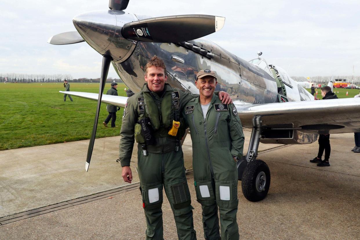 British pilots Matt Jones and Steve Brooks stand in front of the IWC MK IX Silver Spitfire following their return to Goodwood Aerodrome: PA