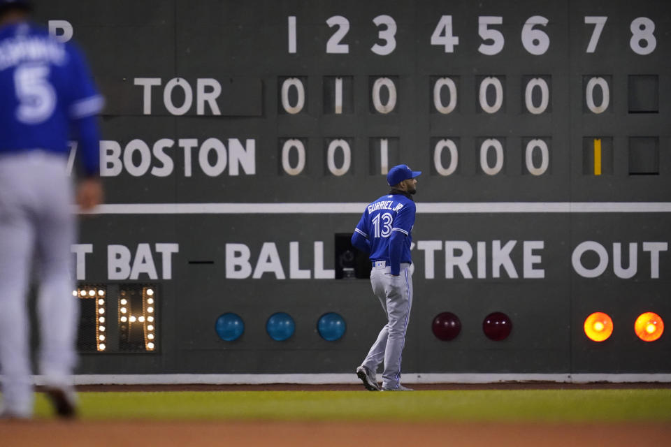 Toronto Blue Jays left fielder Lourdes Gurriel Jr. (13) heads back to his position after a sacrifice fly by Boston Red Sox's Connor Wong scored Bobby Dalbec in the seventh inning of a baseball game, Tuesday, April 19, 2022, at Fenway Park in Boston. (AP Photo/Charles Krupa)