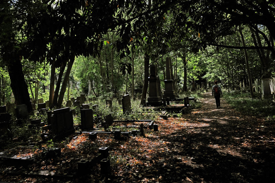 A woman walks through Tower Hamlets Cemetery Park in east London. (Photo by Yui Mok/PA Images via Getty Images)