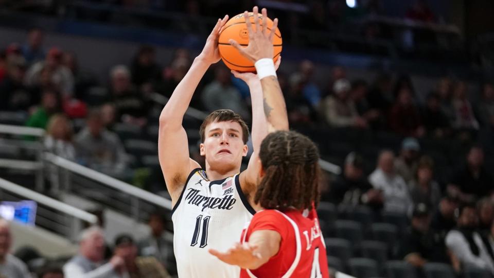 March 22, 2024;  Indianapolis, IN, USA;  Marquette Golden Eagles guard Tyler Kolek (11) shoots against Western Kentucky Hilltoppers guard Khristian Lander (4) in the first half of the first round of the 2024 NCAA Tournament at Gainbridge FieldHouse