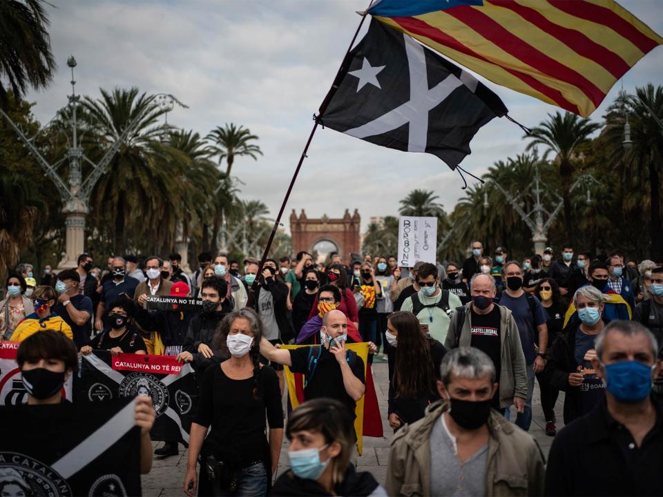 Catalan separatist demonstrators during a protest in Barcelona on 9 October against the visit of Spanish King Felipe VI and Prime Minister Pedro Sanchez (AP)